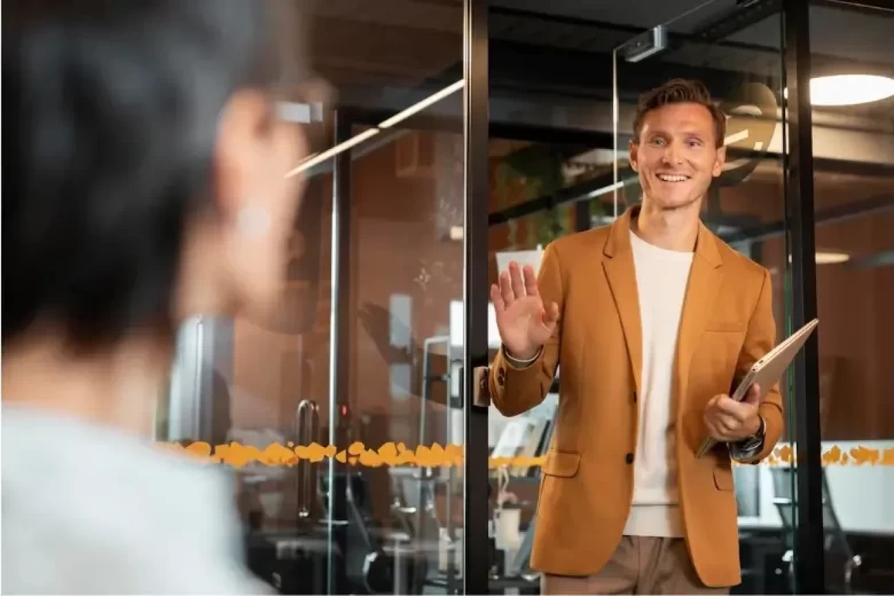 Employee greeting a colleague at work