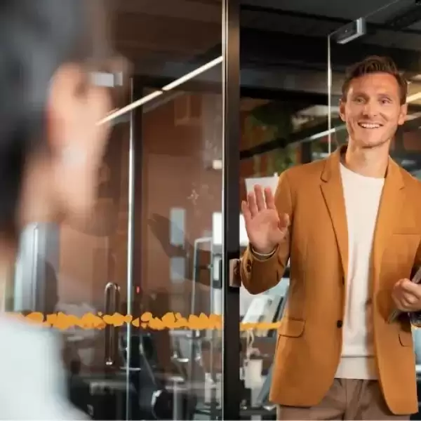 Employee greeting a colleague at work