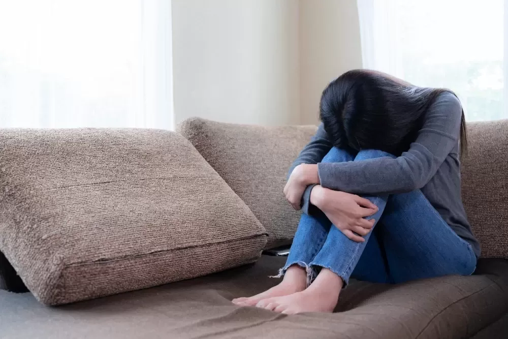 Person Sitting Alone While Coping with Anxiety and Depression